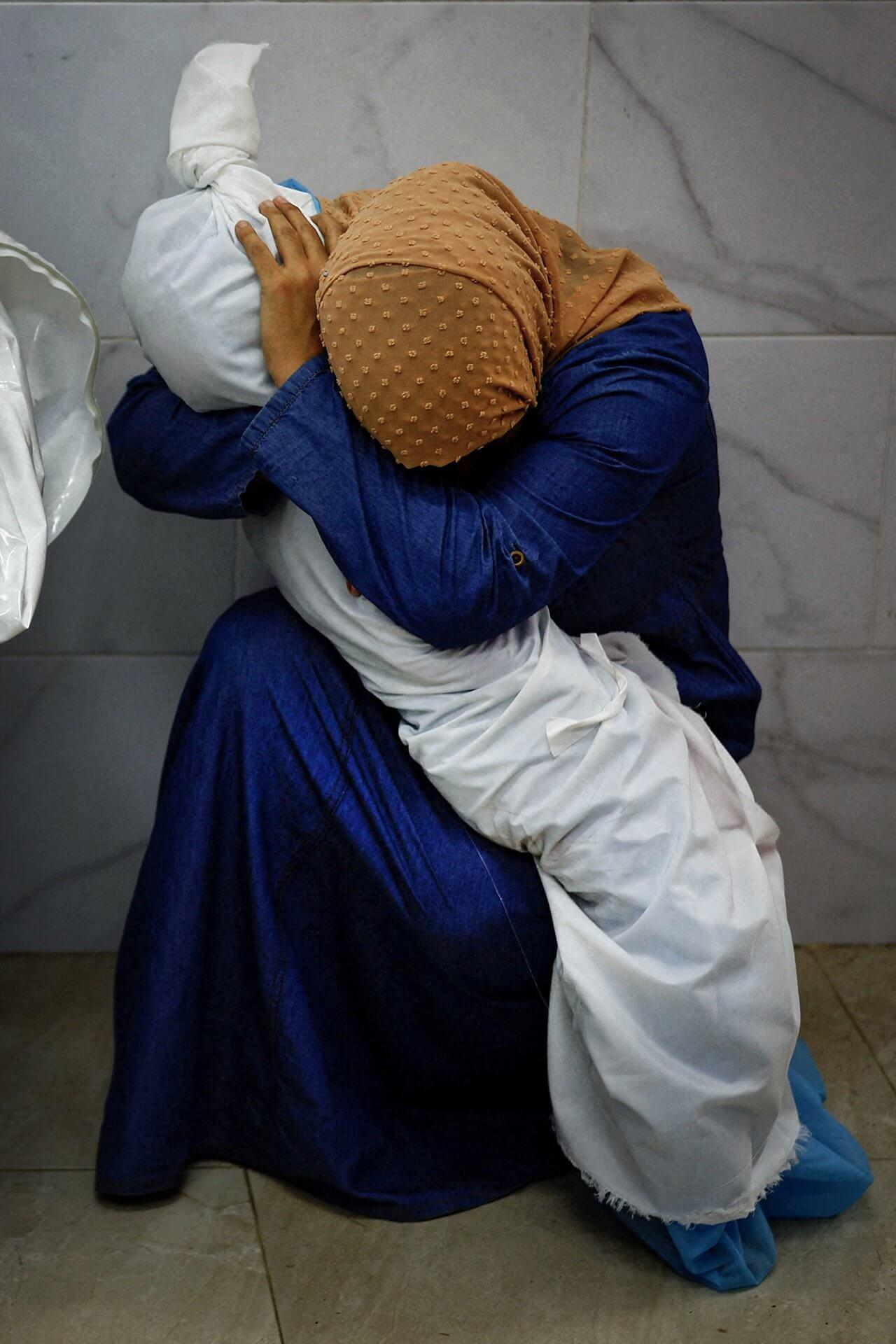 A Palestinian woman holds the body of her dead niece